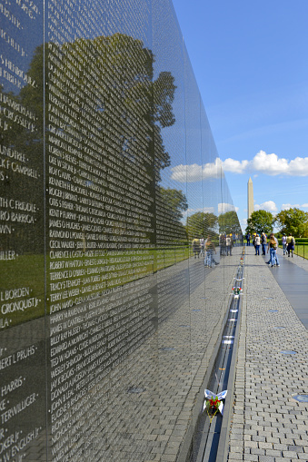 People reviewing the names on the Vietnam War Memorial wall in Washington DC