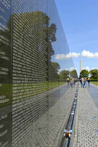 People reviewing the names on the Vietnam War Memorial wall in Washington DC