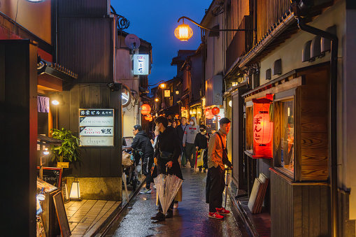 Kyoto, Japan - April 15, 2023: view of the Ponto-cho district at night, with unidentified people. It is a hanamachi district in Kyoto, Japan, known for its geisha and maiko culture