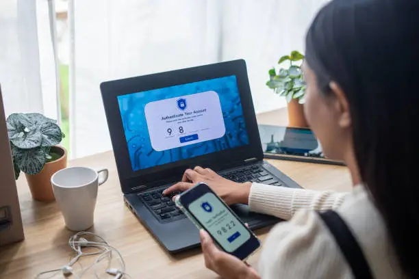 Photo of Two-Factor Authentication (2FA) security login in securely to her laptop