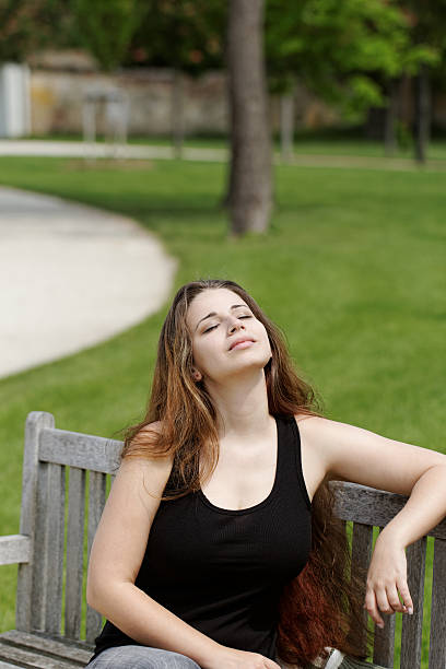 istock pretty young girl on a bench 178827027