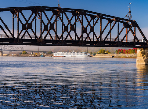 River cruise boat docked in Dubuque IA under Railroad bridge