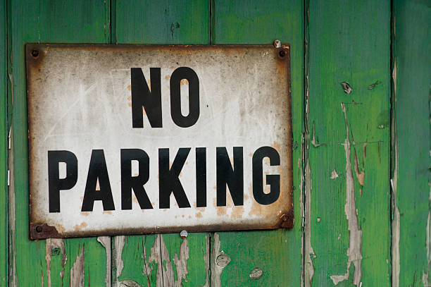 Old no parking sign on garage door stock photo