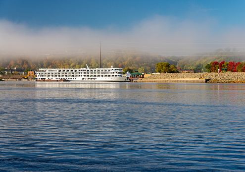 River cruise boat docked in Dubuque IA on misty autumn morning