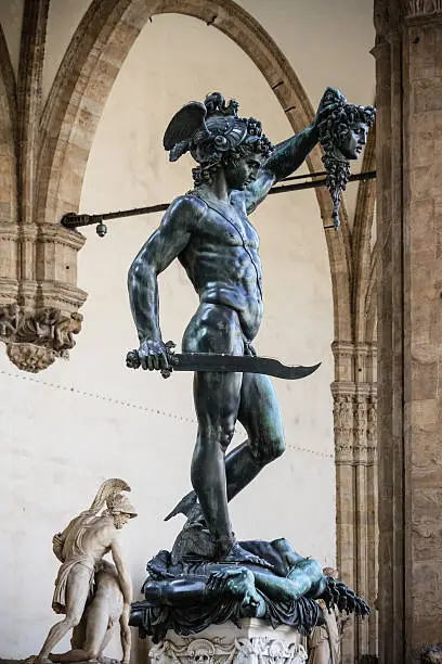 Perseus holding head of Medusa, bronze statue made by Benvenuto Cellini between 1545 and 1554 and currently exposed in Loggia de Lanzi, Piazza della Signoria, Florence, Italy.