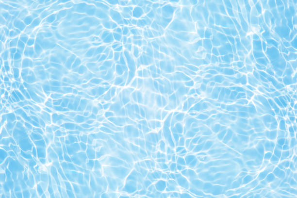 istock Defocus blurred transparent blue colored clear calm water surface texture with splashes reflection. Trendy abstract nature background. Water waves in sunlight with copy space. Blue watercolor shine. 1788297326