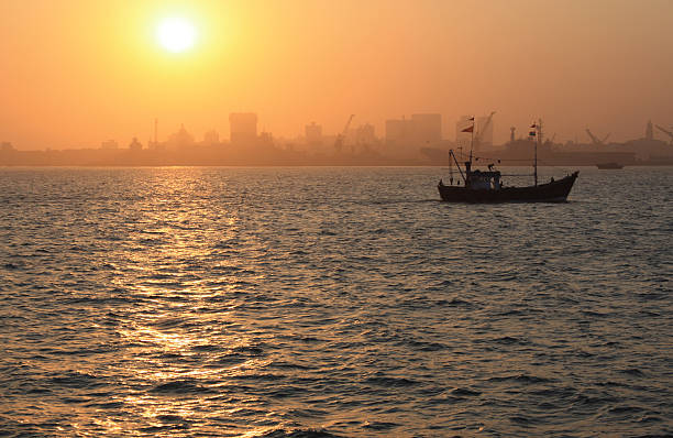 istock Fishing Boat in Mumbai Harbour at Sunset 178829943