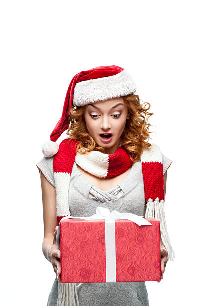 istock young red-haired surprised girl holding christmas gift 178830013