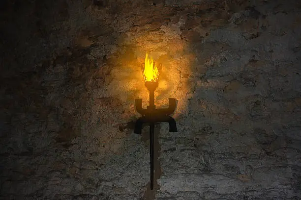 Photo of torch on the wall of an old castle