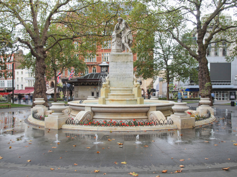 Statue of William Shakespeare (year 1874) in Leicester square, London, UK - isolated over white