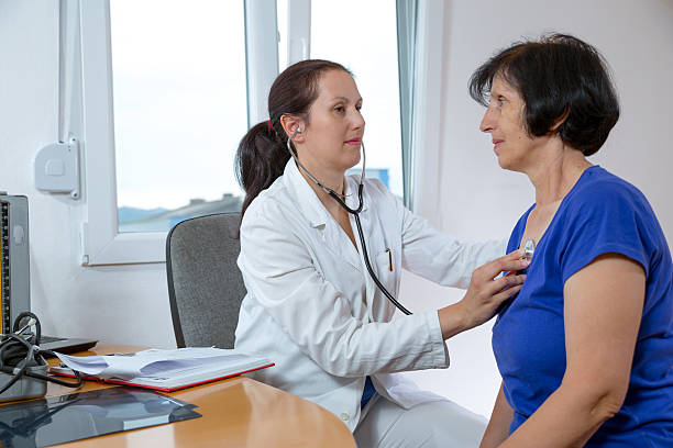 istock Young doctor examining her senior patient with a stethoscope 178831367