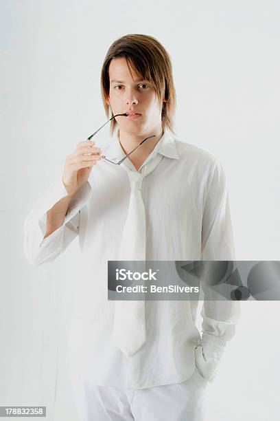 Male Model In White Outfit With Thinking Expression Stock Photo - Download Image Now