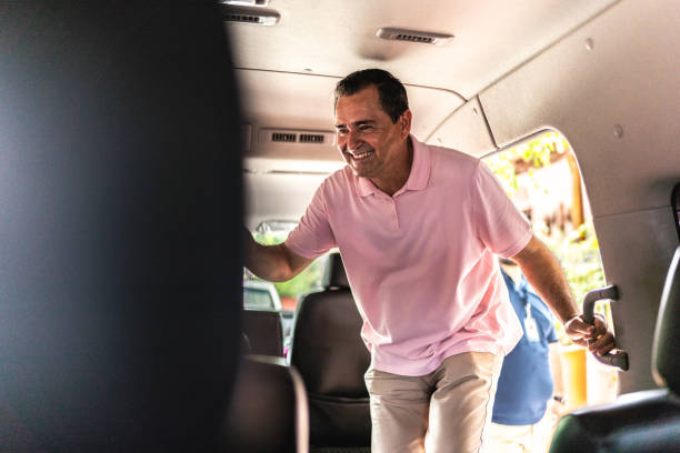 istock Mature tourist man getting into a tour van 1788328353
