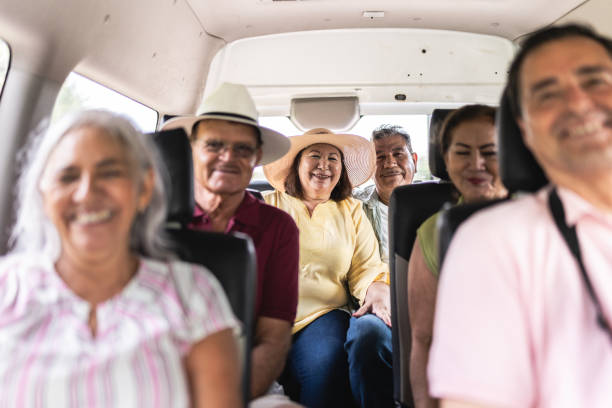 Portrait of a senior tourists inside a van