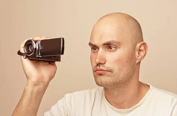 Young man wearing a picture using a camera