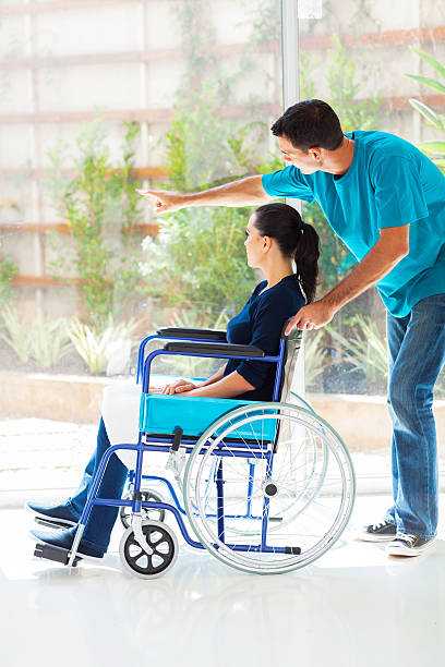 istock caring husband and disabled wife looking outside window 178833467