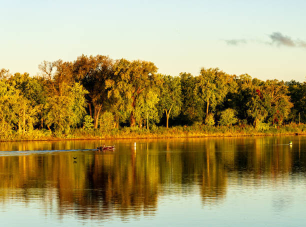 Calm water on Minnesota lake. Autumn colored trees reflecting