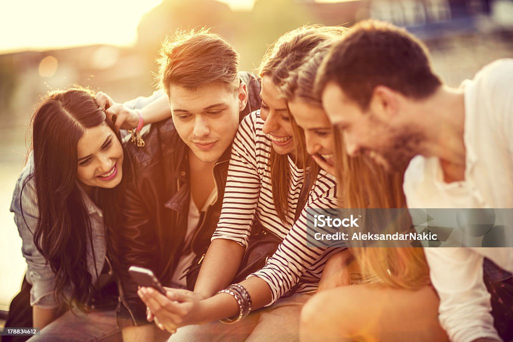 Group of friends with a smartphone 20-24 Years Stock Photo