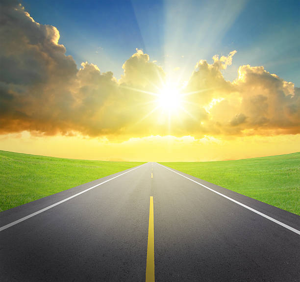 istock sunrise with asphalt road and green grass 178835685