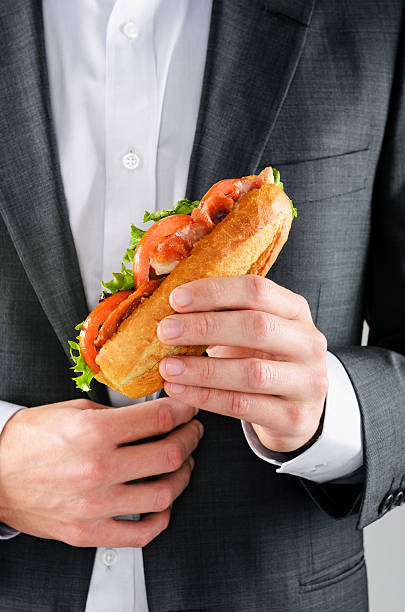 istock Man in suit holding lunch sandwich 178837451