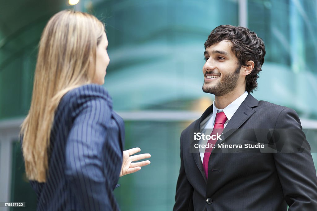 Business meeting Portrait of young business people talking outdoor in a modern urban setting Business Person Stock Photo