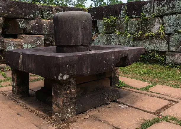 Vietnam, Shivalingam in the Yoni at My Son Cham Sanctuary. A very thick example placed on a wide table-like structure. Built by the medieval Cham culture, a Hindu inspired population, destroyed and replaced by a Muslim culture, introduced by sea traders.