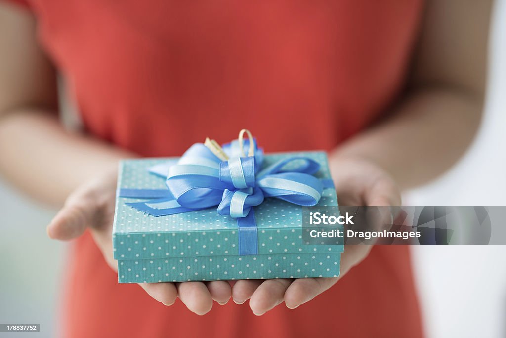 For you! Close-up of female hands holding a present Adult Stock Photo