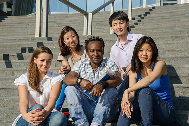 istock Multiethnic group of university students sitting on steps 178839019