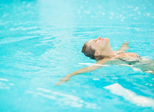 istock Young woman swimming in pool 178839229