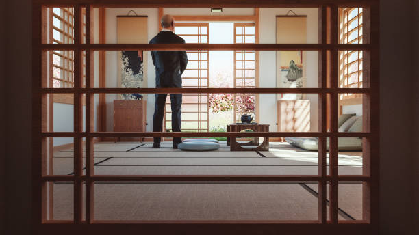 Japanese temple with pensive man standing. 3D generated image, generic and made up location. Illustrations on the wall are from roughly 18st century.