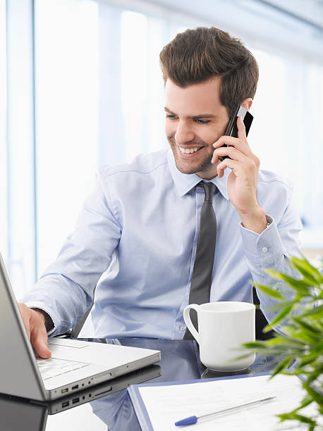 istock Smiling businessman talking on a mobile phone. 178840776