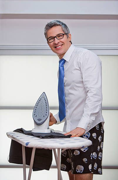 istock Portrait of a businessman smiling while ironing pants 178841750