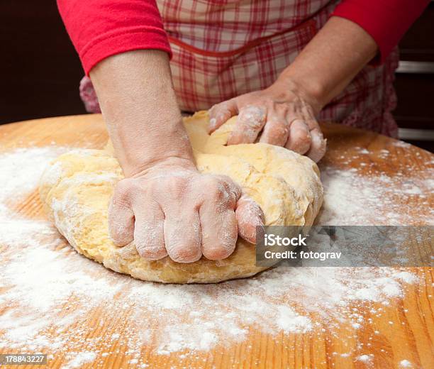 Womans Hands Knead Dough On Wooden Table Stock Photo - Download Image Now - Adult, Apron, Baked Pastry Item