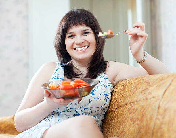 istock positive ordinary woman eats vegetables 178843791