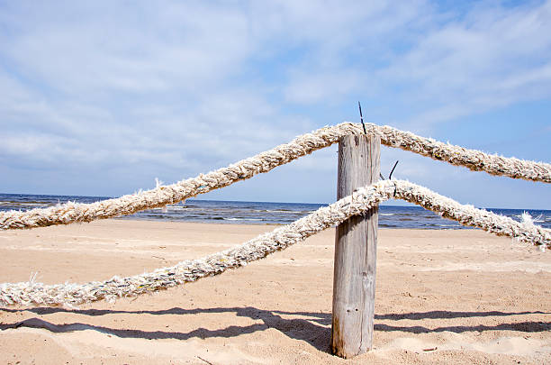 old ropes fence on resort beach nea sea