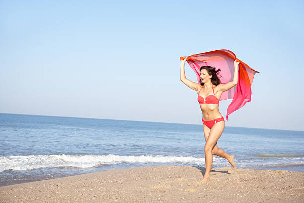 istock Young woman running on beach 178846918