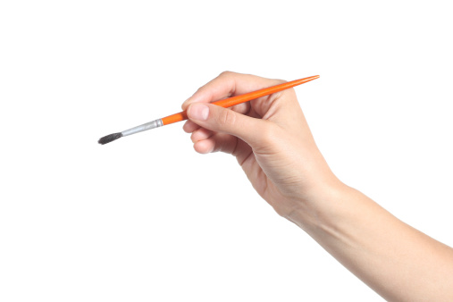 Woman hand using a little paintbrush isolated on a white background
