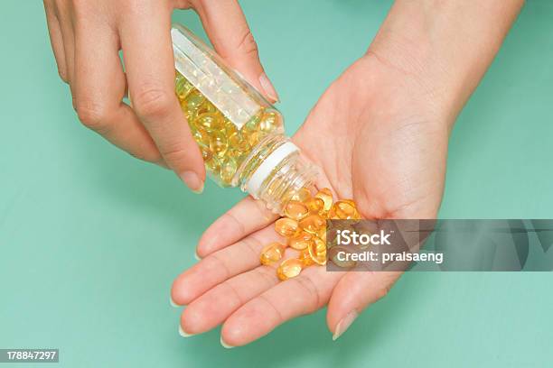 Woman S Hand Take Vitamin Omega3 Fish Oil Pills Stock Photo - Download Image Now - Anti Aging, Capsule - Medicine, Cod Liver Oil