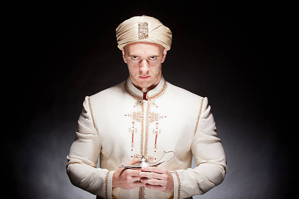 Young man in genie costume with magic lamp