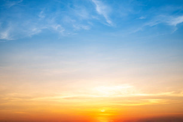 istock Real amazing Beautiful sunrise and luxury soft gradient orange gold clouds with sunlight on the blue sky perfect for the background, take in everning, Twilight sunset sky with gentle colorful clouds 1788481543