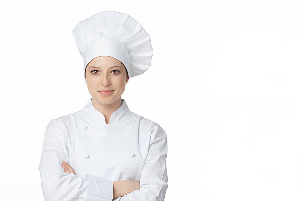 Young chef A young, female chef in a traditional hat and coat. chefs whites stock pictures, royalty-free photos & images
