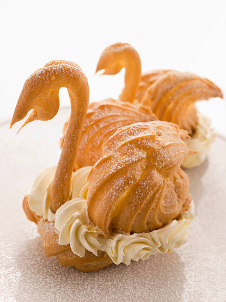 Two Choux Swans filled with Chantilly Cream Sprinkled with Icing Sugar