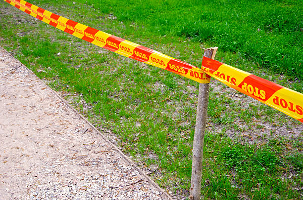 istock red and yellow stop ribbon in the park 178850288