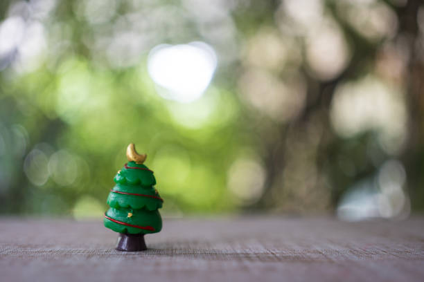 Mini cute Christmas trees on a blurred nature. Christmas and Happy New Year concept.