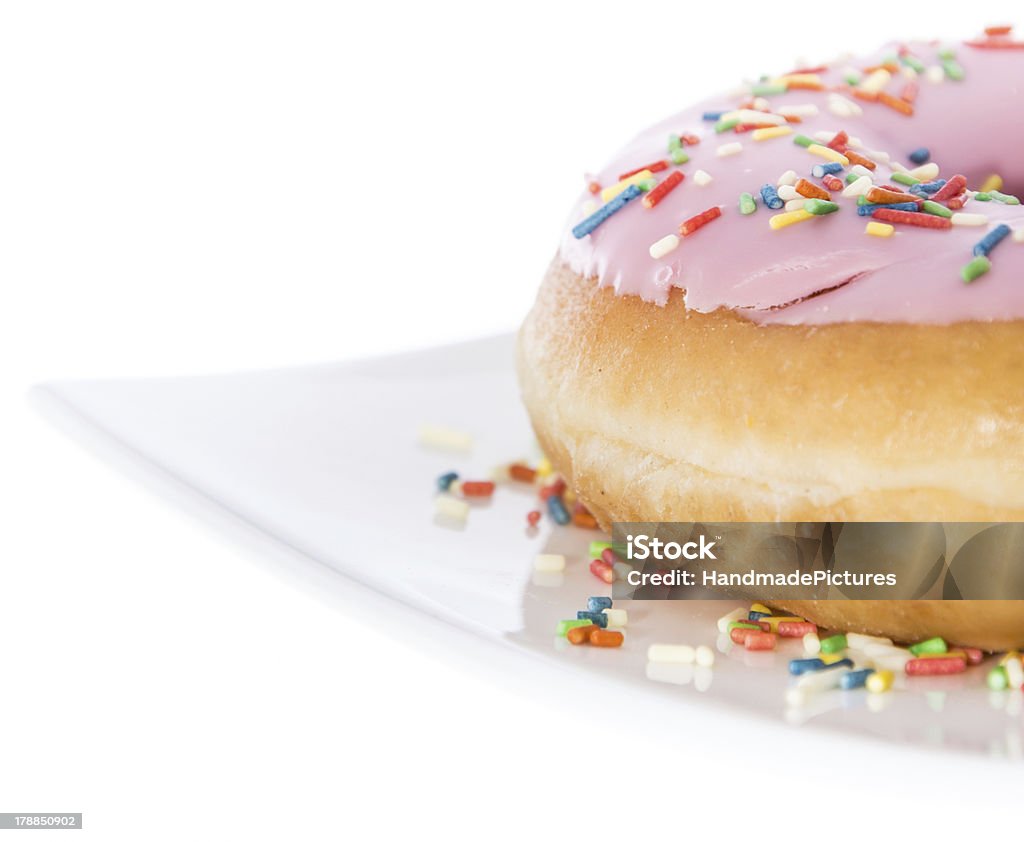 Pink Donut on a plate (white background) Pink Donut on a plate isolated on white background Baked Stock Photo