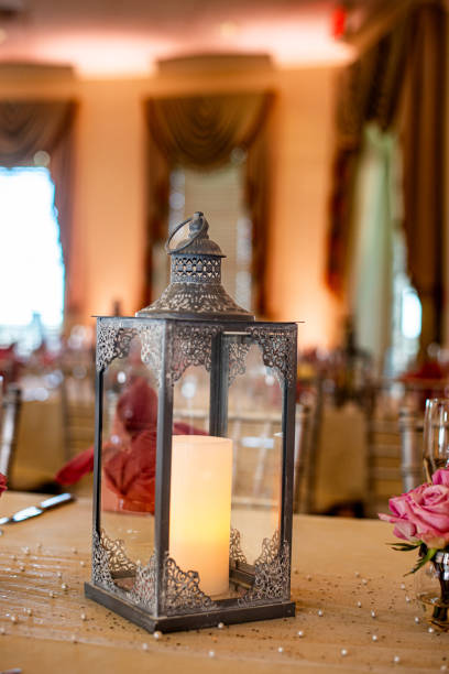 istock Black ornate candle lantern centerpiece on wood table at Wedding reception 1788518585