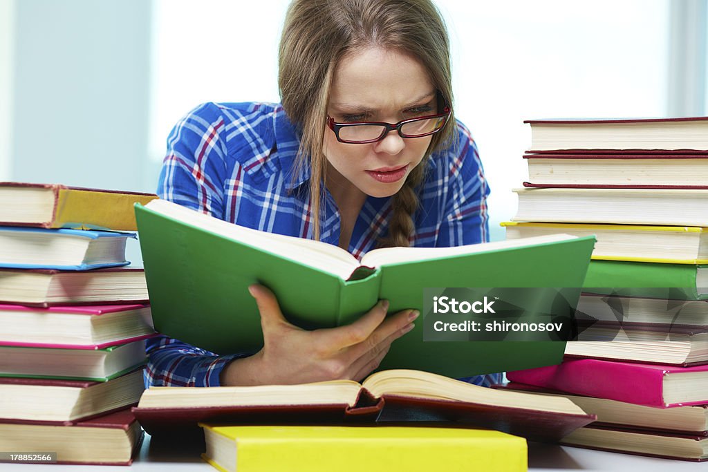 Diligence Diligent student being absorbed in studying Adult Stock Photo
