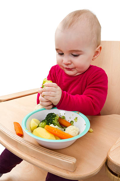 istock young child eating in high chair 178852595