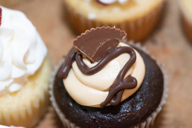 istock Chocolate cup cakes with whip cream and chocolate candy toppings on dessert table wedding reception 1788528533