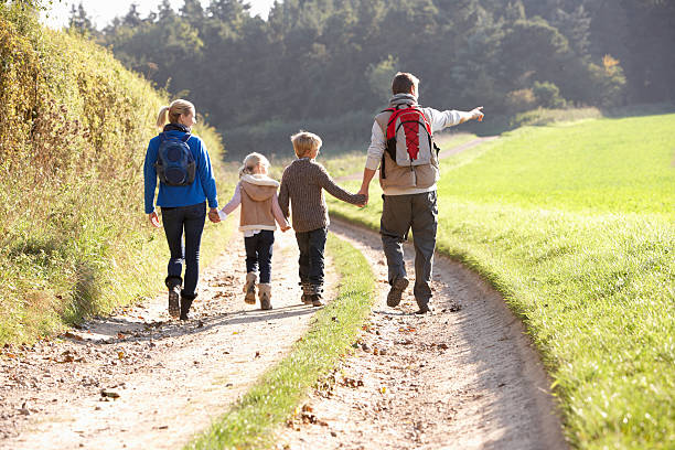 istock Young family walking in park 178854099